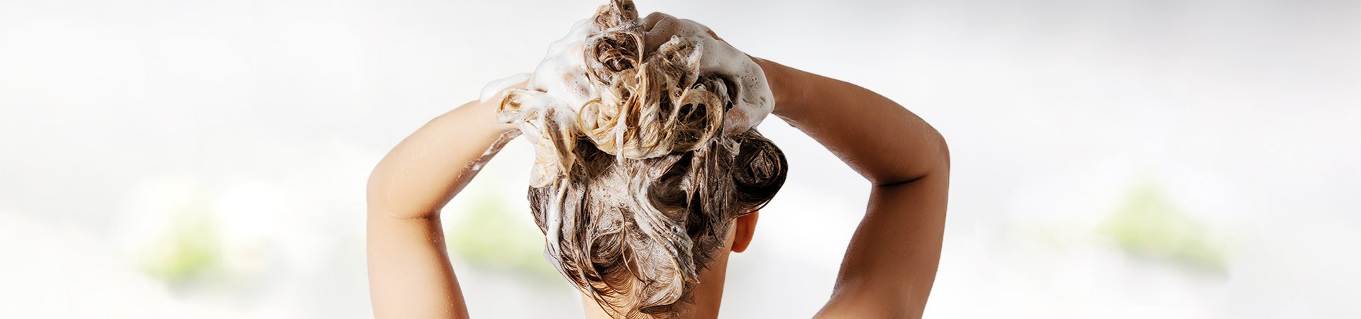 Blonde woman shampooing her hair