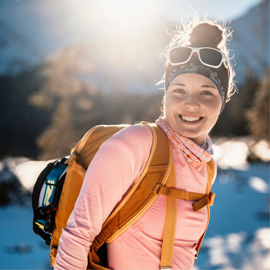 Smiling athlete in snowy landscape