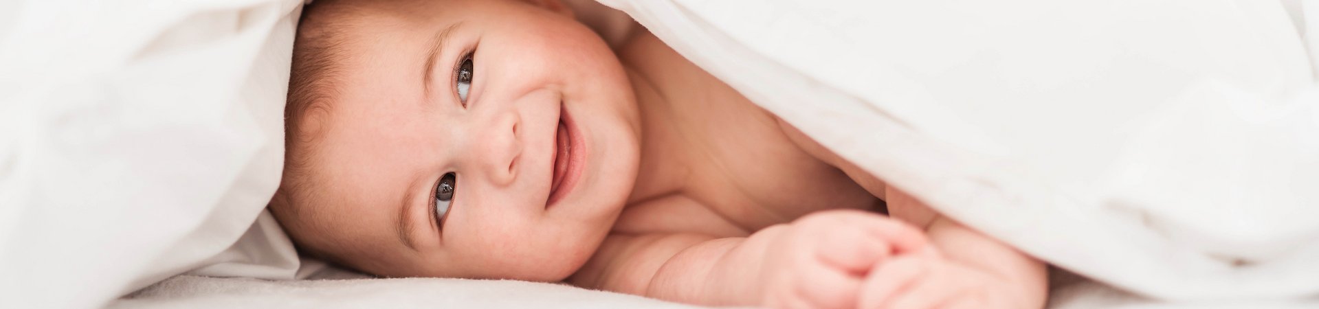 Baby lying down and smiling