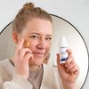 Photo of a woman applying the product.