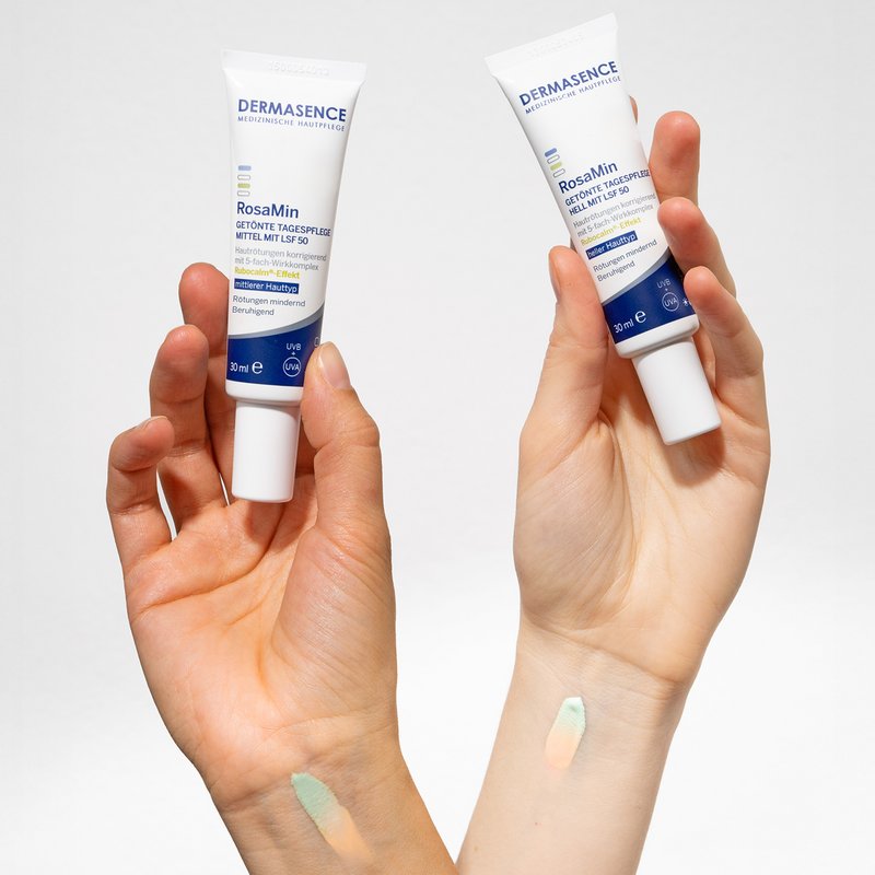 Two hands hold the RosaMin Tinted Day Creams light and medium