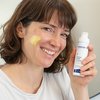 Photo of a woman applying the product.