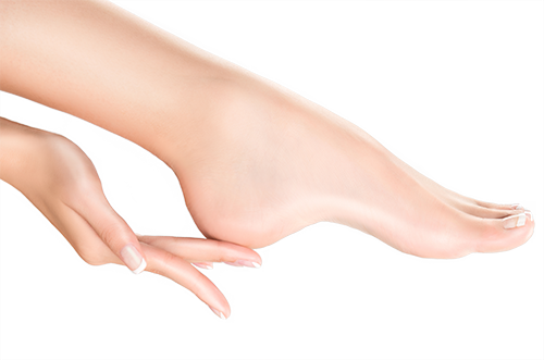 Resistance for stressed and dry feet Woman strokes over well-groomed foot